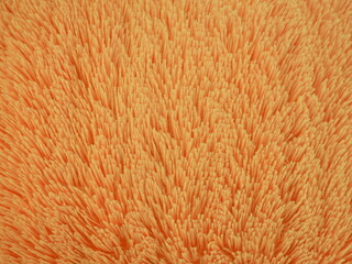  Orange, soft, fluffy wool with long pile. Faux fur texture, background.