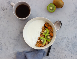 Muesli with white yogurt, kiwi and coconut. Granola. Healthy eating. Vegetarian food. Breakfast.