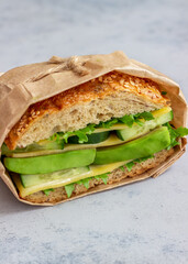 Sandwich with green salad, avocado, cucumber and cheese. Healthy eating. Vegetarian food. Breakfast.