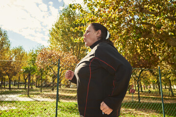 Active senior woman doing healthy exercises outdoors. Jogging