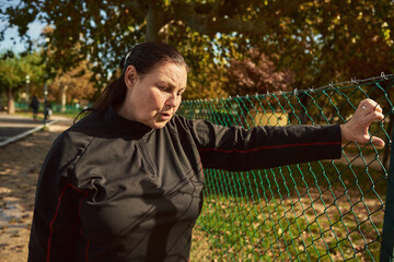 Active senior woman breathing after running outdoors.