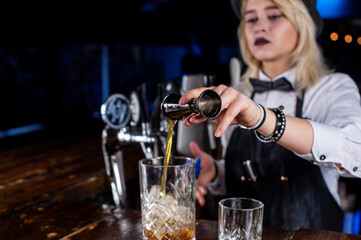 Girl barman makes a cocktail on the pothouse