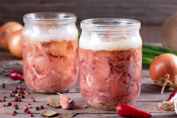 Canned meat in a glass jar on a wooden background