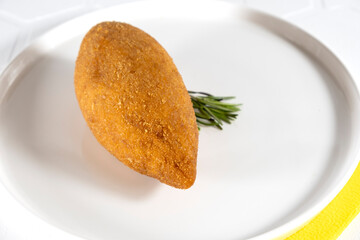 Chicken Kiev cutlet with mashed potatoes and slice on a plate, white background