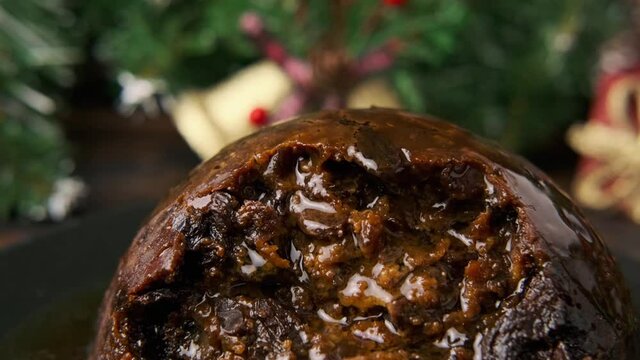 Christmas pudding pours alcohol and ready for fire. British traditional food