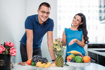 Happy married couple eating fruits. Healthy activity, indoors, cold prevention