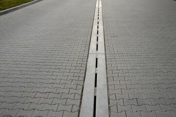 drainage element in interlocking paving concrete gutter with slotted drain from one piece of...