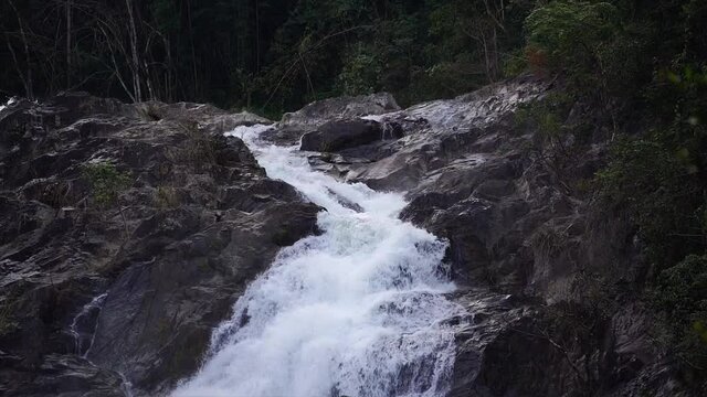 Footage of a tall waterfall in the natural forest