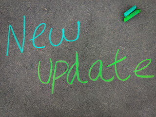 The inscription text on the grey board, New update. Using color chalk pieces.