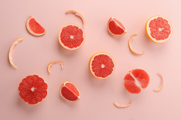 Grapefruit slices on the light pink background.