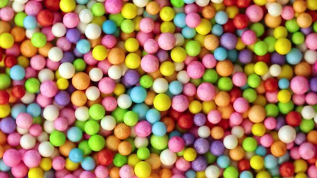 Multicolored balloons top view with circular rotation as background and texture. Holiday and fun concept. Slime Balls Pool with balls for fun and play, flat lay.
