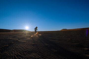 Fototapeta na wymiar Person walking on dune in desert