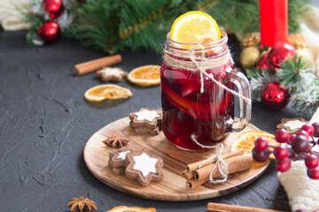 Christmas hot mulled wine with cinnamon cardamom and anise. Dark vintage dirty background. Creative...