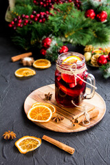Christmas hot mulled wine with cinnamon cardamom and anise. Dark vintage dirty background. Creative atmospheric decoration