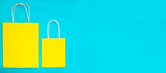 Yellow shopping bags over the blue background. Colorful flatly banner with space for text.