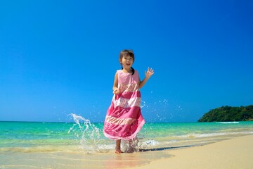 Girl is running in the blue sea. Blue sea.Summer sea travel.Summer beach travel. 