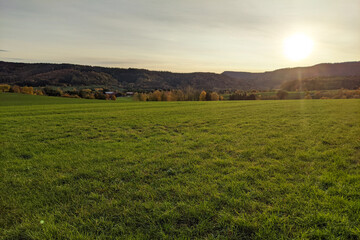 Fototapeta premium sunrise in autumn mountain with field view