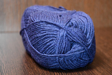 Fototapeta na wymiar a skein of blue yarn in close-up on a dark background