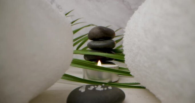spa and wellness - sliding through the white towels over massage stones