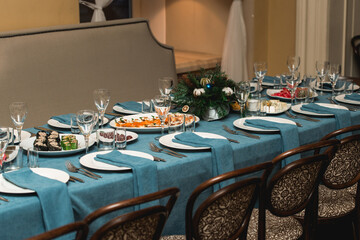 Classic Blue color. Holiday party, decorated table with blue tablecloth. Selective focus. Christmas dinner