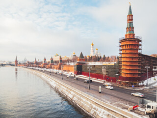 Obraz premium View on Kremlin walls, Ivan the Great bell tower, Beklemishevskaya Tower under re-construction. Architectural landmarks of Moscow, Russia.