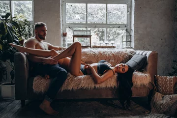 Romantic intimate photo session of a young couple. The guy and the girl spend time together. A love story in a cozy home environment. © dimadasha