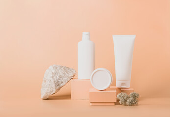 Cosmetic vials tube bottles white on modern abstract podium on pastel background