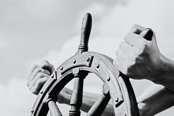 Steering hand wheel ship on sky background, hand hold hand wheel © alzay