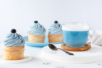 Blue trendy drink from Butterfly pea tea with milk foam and cake for breakfast