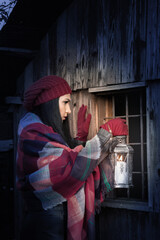 A frightened girl with a candlestick in her hand