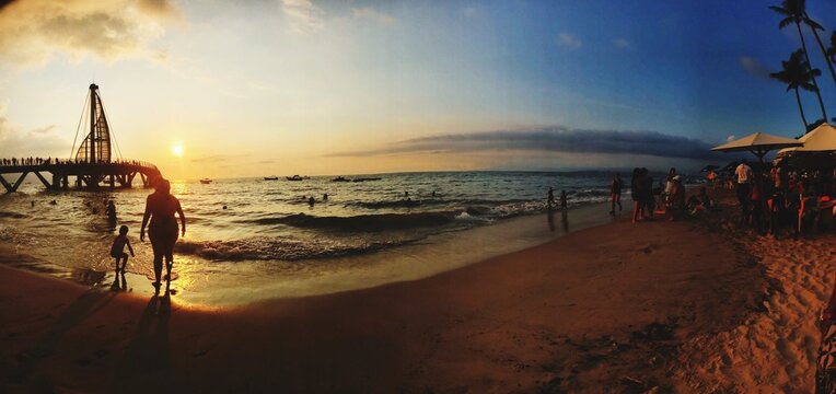 Fish Eye View Of People At Beach Against Sky During Sunset