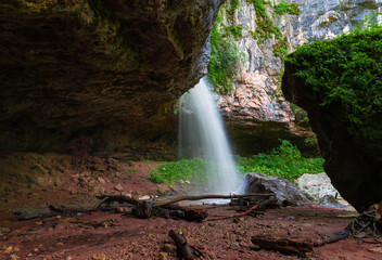 Fototapeta na wymiar Mountain day summer. Waterfall Caucasus, mainsail cave
