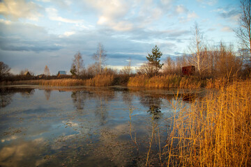 Clouds in the sky with reflection in the lake at sunset.