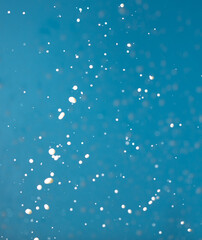 Fototapeta na wymiar Splashes of white milk isolated on a blue background.