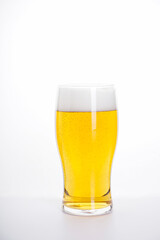 Glass of light beer on a white background