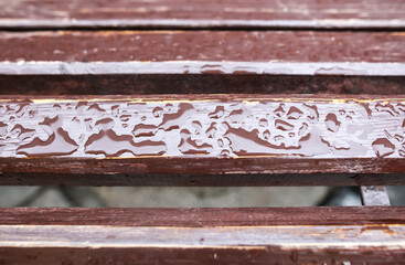 Raindrops on a wooden bench.