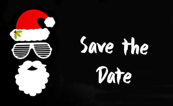 English Text Save The Date. Santa Claus Paper Mask With Christmas Decoration And Accessories. Black Paper Background