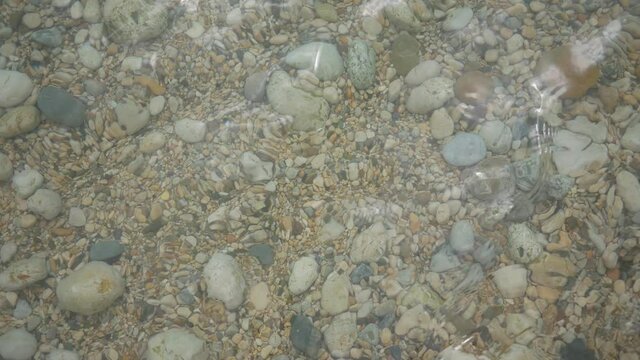 Coast of stones. Pebble beach under the summer sun. Black Sea