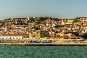 Fototapeta na wymiar A view of the castle hill in the old quarter of Lisbon, Portugal from the Tagus river
