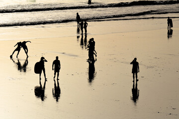 Fototapeta na wymiar silhouettes on the beach at sunset