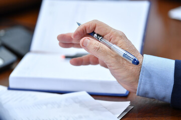 business, hand, office, businessman, pen, document, meeting, people, contract, writing, paper, computer, corporate, working, human, laptop, closeup, work, job, table, agreement, report, person, close-