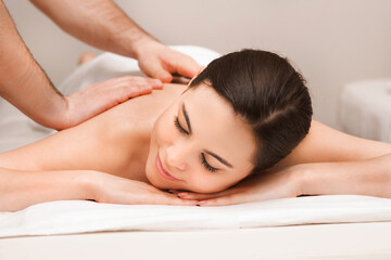Obraz na płótnie Canvas Thai back massage, mixed race woman during a relaxing massage. Anti-stress massage at wellness spa resort