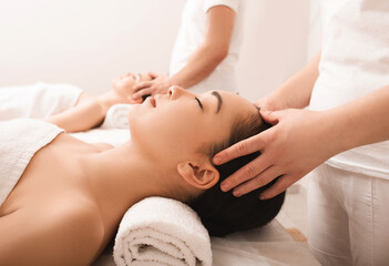 Thai massage. Asian women during anti-stress head massage in wellness salon