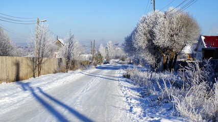 Street in the village in winter, road