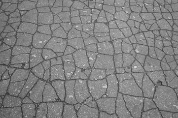 cracked asphalt road background in an old Park 