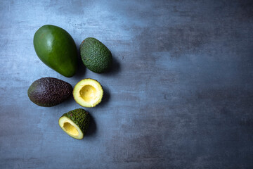 Fresh avocado on gray base, seen from above, free space