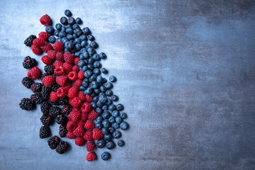 berries mix on an abstract gray background, seen from above