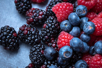 berries mix on an abstract gray background, seen from above