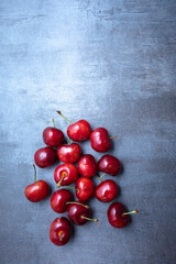 Ripe sweet cherry spread on a blue background. seen from above. Free space for edits