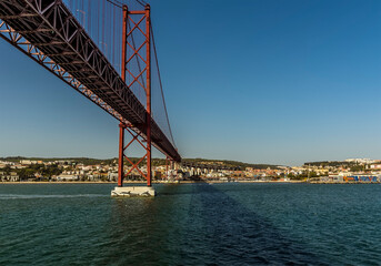Cruising up the Tagus river and sailing under the bridge named after the 25th April revolution in Lisbon, Portugal